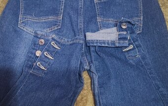 Dżinsy niebieskie, z guzikami na nogawkach, rozm. L - 5